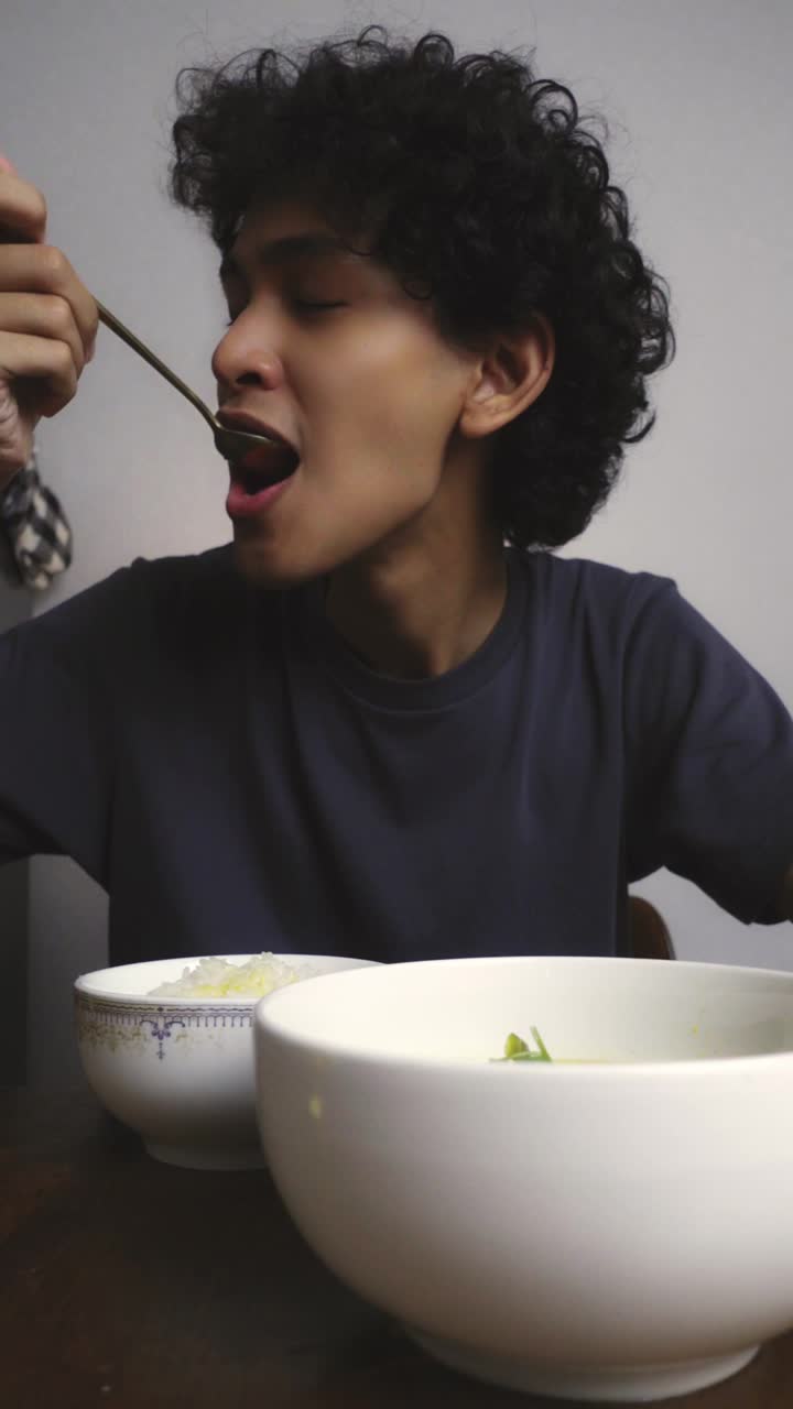 Zwe tasting a bowl of soup
