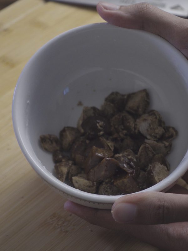 Small chopped pieces of jaggery in a white bowl