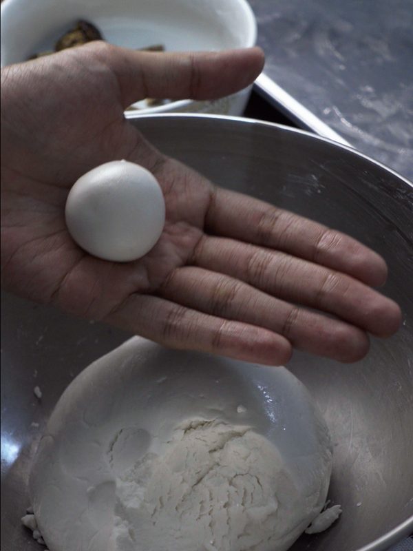 A sealed, smooth rice ball resting in the palm